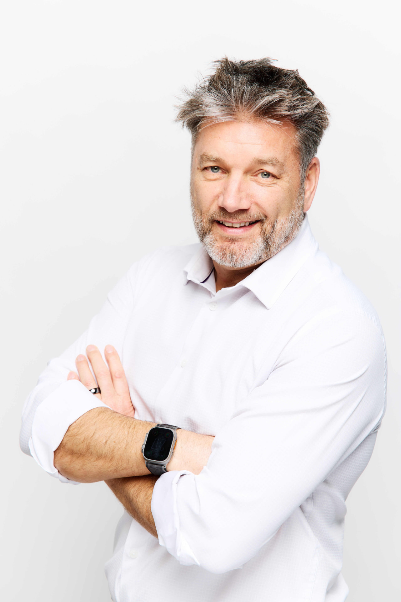 Simon Grice portrait in a white shirt with arms crossed